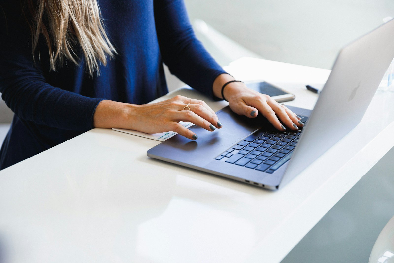 Gros plan sur des mains rédigeant un email sur un clavier d'ordinateur